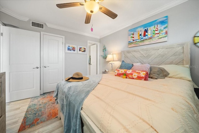 8750 Midnight Pass Rd Unit 501, Sarasota, FL 34242 - bedroom featuring light wood-style floors, ornamental molding, a closet, and a ceiling fan