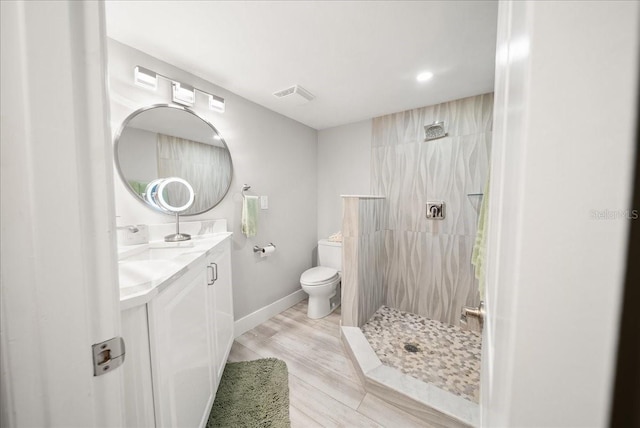 8750 Midnight Pass Rd Unit 501, Sarasota, FL 34242 - full bath featuring vanity, a tile shower, wood finished floors, and recessed lighting