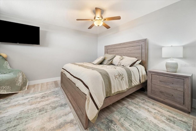 8750 Midnight Pass Rd Unit 501, Sarasota, FL 34242 - bedroom with light wood-style flooring and ceiling fan