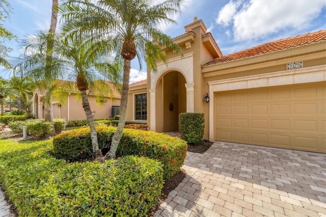 5179 Cantabria Crst, Sarasota, FL 34238 - mediterranean / spanish-style house featuring stucco siding, a tile roof, driveway, and a garage
