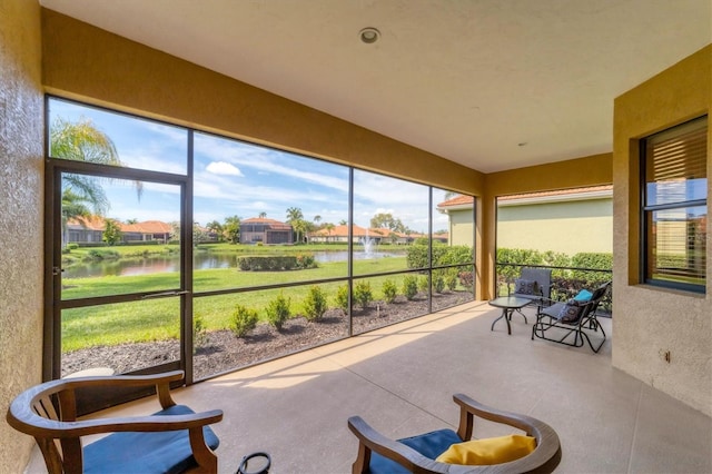 5179 Cantabria Crst, Sarasota, FL 34238 - sunroom featuring a water view, healthy amount of natural light, concrete flooring, and a residential view