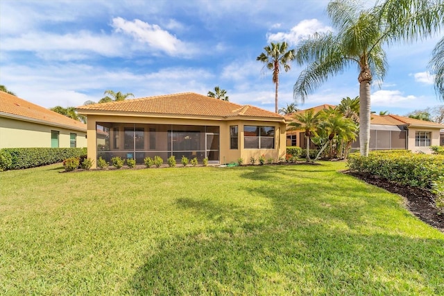5179 Cantabria Crst, Sarasota, FL 34238 - rear view of house with stucco siding, a sunroom, a tiled roof, and a yard