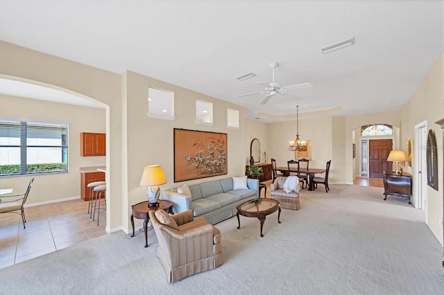 5179 Cantabria Crst, Sarasota, FL 34238 - living room featuring arched walkways, healthy amount of natural light, light colored carpet, and a ceiling fan
