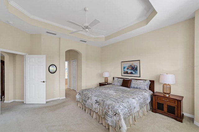 5179 Cantabria Crst, Sarasota, FL 34238 - carpeted bedroom featuring arched walkways, a raised ceiling, ceiling fan, crown molding, and a closet