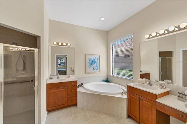 5179 Cantabria Crst, Sarasota, FL 34238 - full bath featuring a stall shower, tile patterned floors, two vanities, and a garden tub