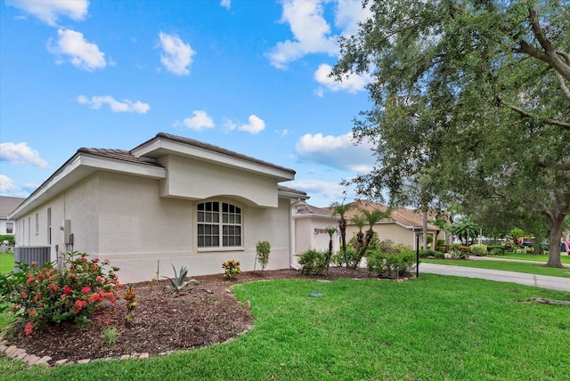 11508 30th Cv E, Parrish, FL 34219 - view of front facade with stucco siding, a front yard, driveway, and a garage
