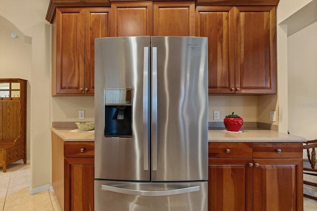 11508 30th Cv E, Parrish, FL 34219 - kitchen with stainless steel fridge with ice dispenser, light countertops, light tile patterned flooring, and brown cabinets
