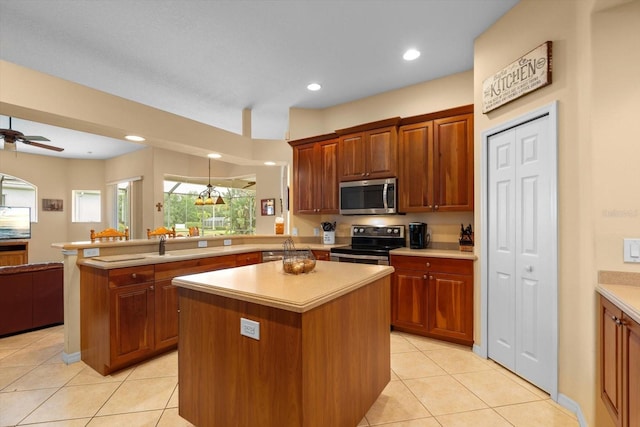 11508 30th Cv E, Parrish, FL 34219 - kitchen featuring appliances with stainless steel finishes, a peninsula, light countertops, open floor plan, and recessed lighting