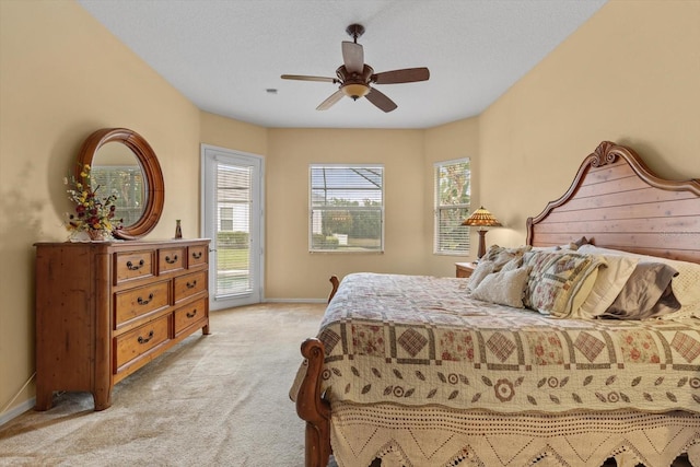 11508 30th Cv E, Parrish, FL 34219 - bedroom with light carpet, access to exterior, and a ceiling fan