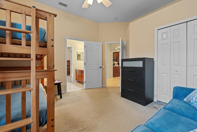 11508 30th Cv E, Parrish, FL 34219 - bedroom featuring light carpet, a closet, connected bathroom, and ceiling fan