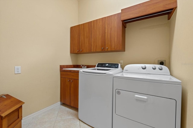 11508 30th Cv E, Parrish, FL 34219 - laundry room featuring washing machine and dryer, cabinet space, and light tile patterned flooring