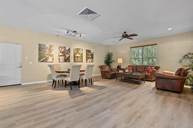 11508 30th Cv E, Parrish, FL 34219 - living area with light wood-type flooring, a ceiling fan, a textured ceiling, and recessed lighting