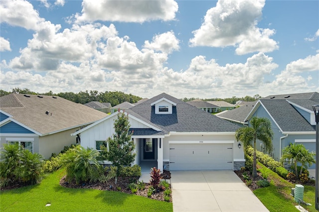 8706 Arrow Creek Dr, Parrish, FL 34219 - view of front of house with a shingled roof, a garage, concrete driveway, board and batten siding, and a residential view