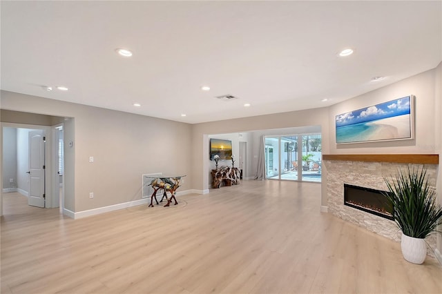 444 S Polk Dr, Sarasota, FL 34236 - living room featuring light wood-style flooring, recessed lighting, and a glass covered fireplace