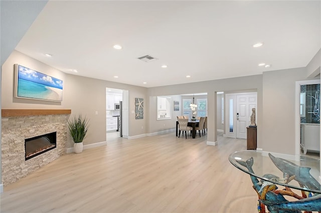 444 S Polk Dr, Sarasota, FL 34236 - living area with light wood finished floors, a stone fireplace, and recessed lighting
