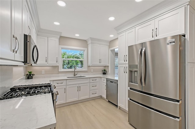444 S Polk Dr, Sarasota, FL 34236 - kitchen featuring stainless steel appliances, light wood-type flooring, white cabinets, recessed lighting, and light stone countertops