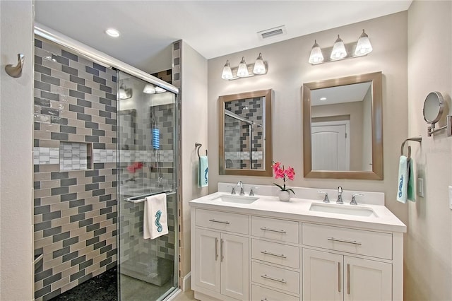 444 S Polk Dr, Sarasota, FL 34236 - bathroom with a shower stall, double vanity, and recessed lighting
