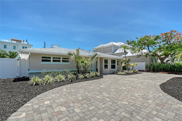 444 S Polk Dr, Sarasota, FL 34236 - view of front of property with stucco siding and curved driveway