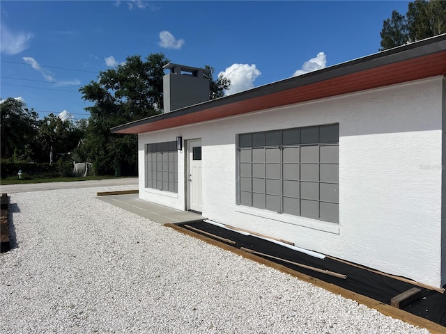4122 N Lockwood Ridge Rd, Sarasota, FL 34234 - view of side of property with a chimney and stucco siding