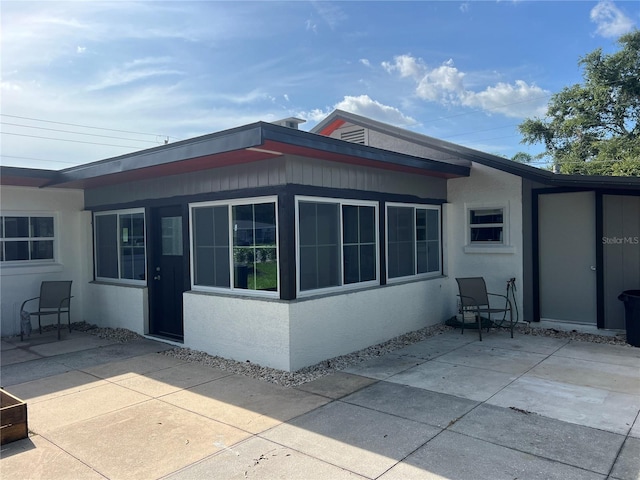 4122 N Lockwood Ridge Rd, Sarasota, FL 34234 - back of house with a patio and stucco siding