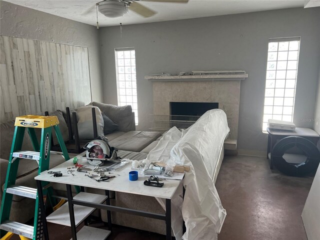 4122 N Lockwood Ridge Rd, Sarasota, FL 34234 - living area featuring a ceiling fan, finished concrete floors, and a tile fireplace