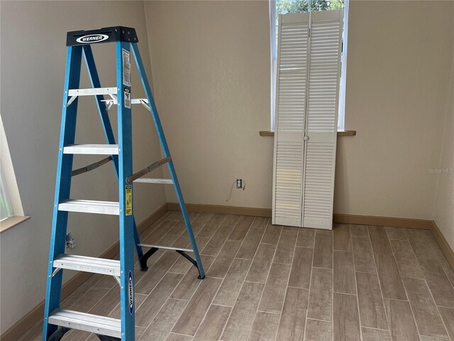 4122 N Lockwood Ridge Rd, Sarasota, FL 34234 - unfurnished bedroom with wood finished floors and baseboards