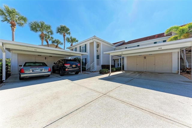803 Montrose Dr Unit 201, Venice, FL 34293 - view of front facade featuring covered parking and stucco siding