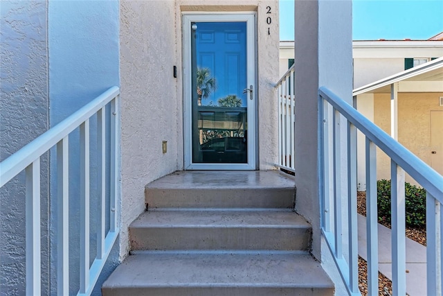 803 Montrose Dr Unit 201, Venice, FL 34293 - view of exterior entry featuring stucco siding