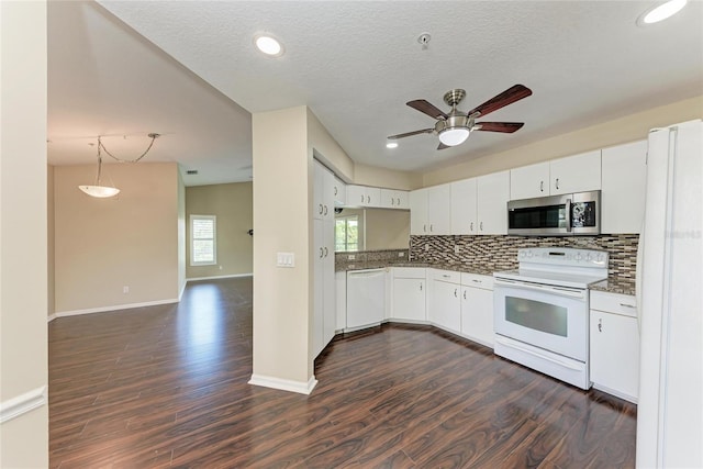 803 Montrose Dr Unit 201, Venice, FL 34293 - kitchen with white appliances, dark wood-style flooring, backsplash, plenty of natural light, and recessed lighting