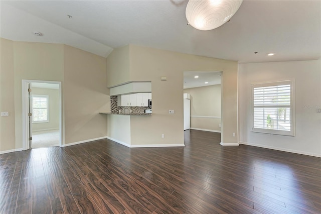 803 Montrose Dr Unit 201, Venice, FL 34293 - unfurnished living room featuring dark wood-style floors, lofted ceiling, and recessed lighting