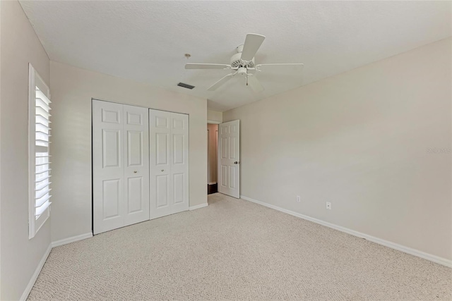 803 Montrose Dr Unit 201, Venice, FL 34293 - unfurnished bedroom featuring carpet floors, a closet, and a ceiling fan