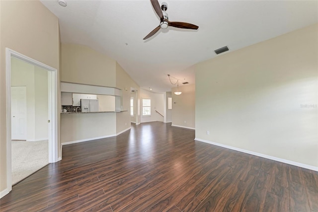 803 Montrose Dr Unit 201, Venice, FL 34293 - unfurnished living room featuring vaulted ceiling, a ceiling fan, and dark wood-style flooring