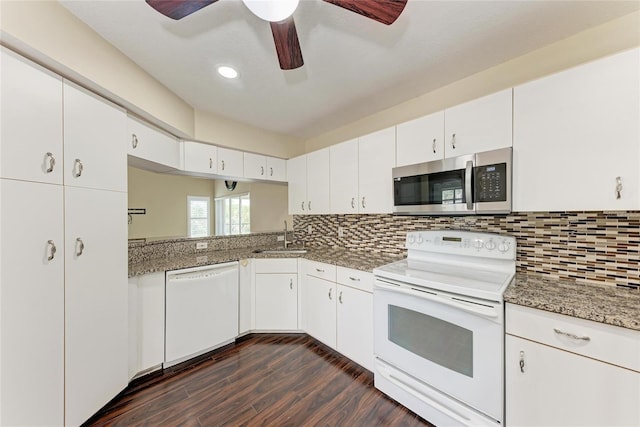 803 Montrose Dr Unit 201, Venice, FL 34293 - kitchen featuring white appliances, dark wood-style flooring, a ceiling fan, backsplash, and white cabinets