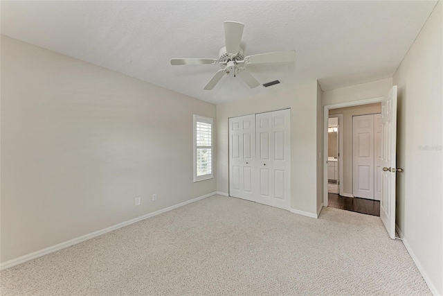 803 Montrose Dr Unit 201, Venice, FL 34293 - unfurnished bedroom featuring carpet, a closet, and a ceiling fan