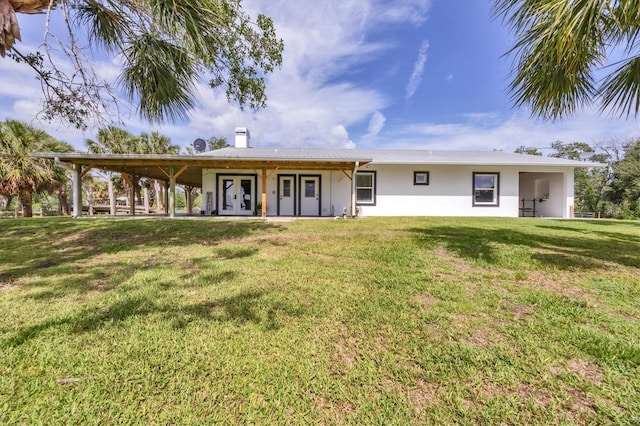 39700 State Road 70 E, Myakka City, FL 34251 - back of house with french doors, a chimney, a yard, and stucco siding