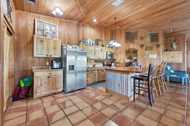 39700 State Road 70 E, Myakka City, FL 34251 - kitchen with appliances with stainless steel finishes, wood ceiling, wooden walls, a breakfast bar, and light tile patterned flooring