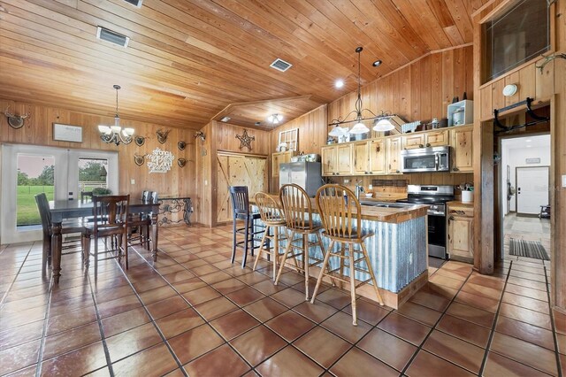 39700 State Road 70 E, Myakka City, FL 34251 - kitchen with vaulted ceiling, appliances with stainless steel finishes, wooden ceiling, wooden walls, and a chandelier