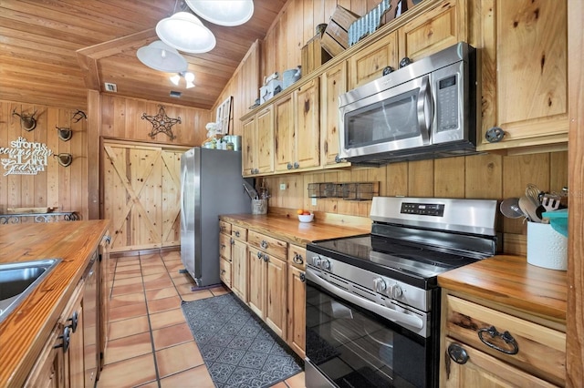 39700 State Road 70 E, Myakka City, FL 34251 - kitchen featuring butcher block counters, appliances with stainless steel finishes, wooden walls, light tile patterned flooring, and wood ceiling