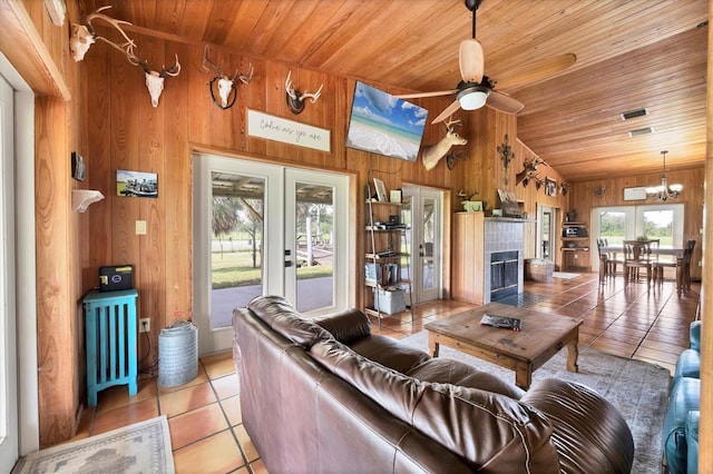 39700 State Road 70 E, Myakka City, FL 34251 - living area with wood ceiling, light tile patterned flooring, wood walls, lofted ceiling, and ceiling fan