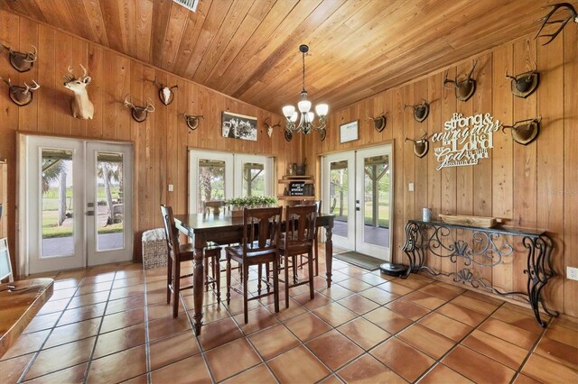 39700 State Road 70 E, Myakka City, FL 34251 - dining room featuring french doors, wooden walls, tile patterned flooring, wooden ceiling, and vaulted ceiling