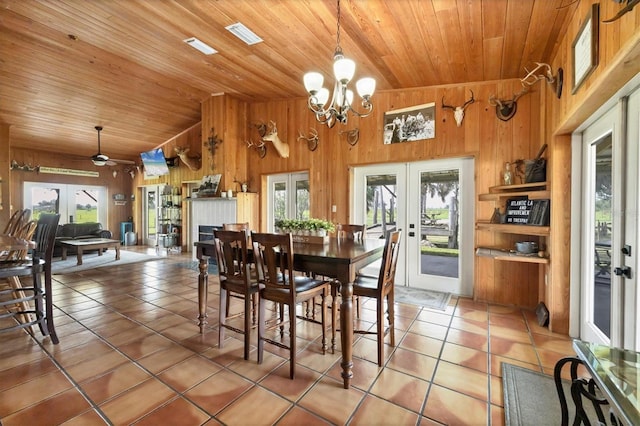 39700 State Road 70 E, Myakka City, FL 34251 - dining room with french doors, plenty of natural light, light tile patterned floors, wooden walls, and wood ceiling