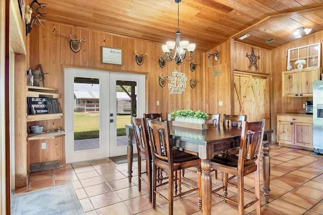 39700 State Road 70 E, Myakka City, FL 34251 - dining room with wood ceiling, wooden walls, light tile patterned flooring, french doors, and vaulted ceiling