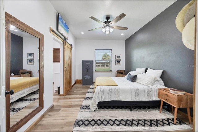39700 State Road 70 E, Myakka City, FL 34251 - bedroom featuring a barn door, light wood finished floors, recessed lighting, and a ceiling fan