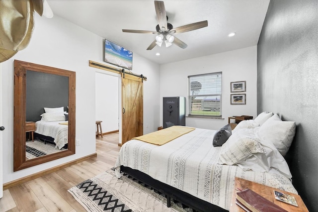 39700 State Road 70 E, Myakka City, FL 34251 - bedroom featuring a barn door, light wood-style floors, recessed lighting, and ceiling fan