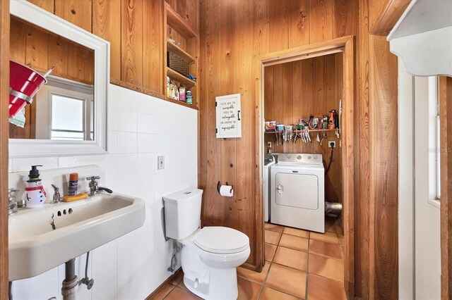 39700 State Road 70 E, Myakka City, FL 34251 - bathroom featuring tile patterned floors, washer and dryer, and wood walls