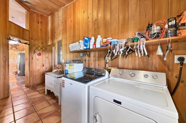 39700 State Road 70 E, Myakka City, FL 34251 - laundry room with washer and dryer, wooden walls, electric water heater, light tile patterned flooring, and wood ceiling
