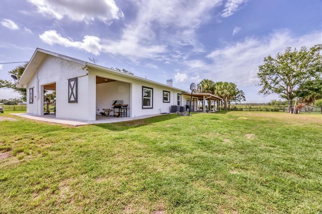 39700 State Road 70 E, Myakka City, FL 34251 - rear view of property featuring stucco siding, a patio, and a yard