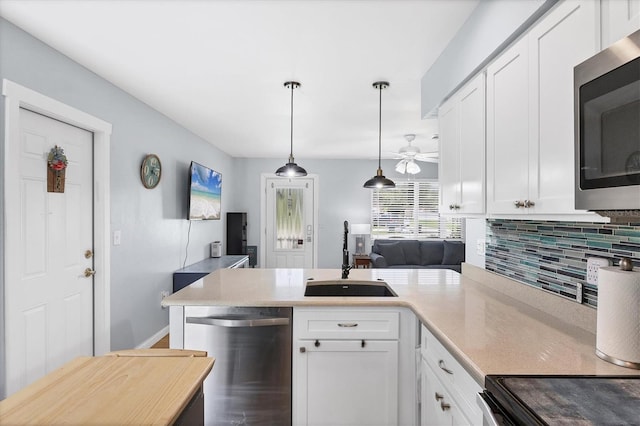 1778 N Salford Blvd, North Port, FL 34286 - kitchen with appliances with stainless steel finishes, backsplash, light countertops, and white cabinets