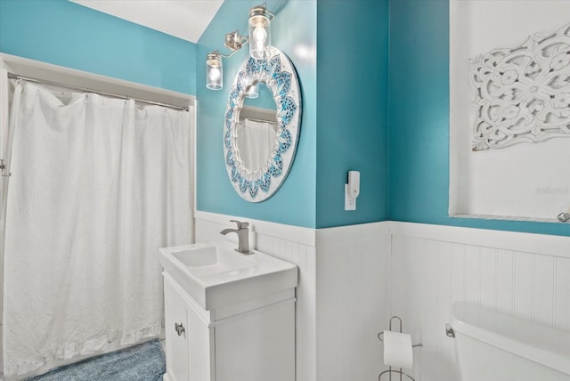 538 Magellan Dr, Sarasota, FL 34243 - bathroom featuring a wainscoted wall, vanity, and a shower with shower curtain