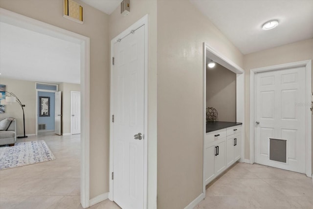 538 Magellan Dr, Sarasota, FL 34243 - corridor featuring baseboards and light tile patterned flooring